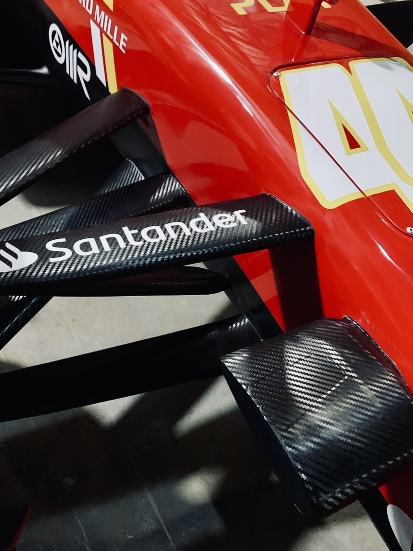 Close-up of painted bodywork and composite aero surfaces on a completed display car